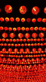 Low angle view of illuminated lanterns hanging at night
