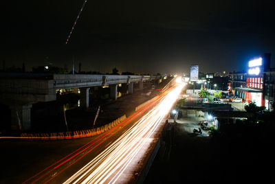 Light trails on road in city at night