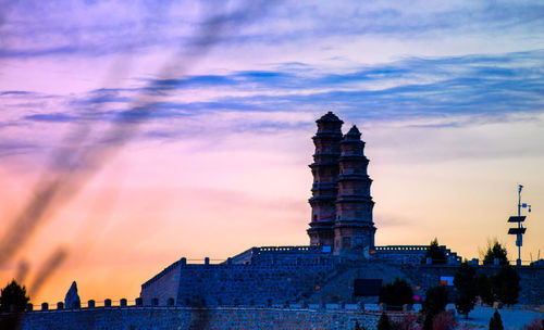 Historic building against sky during sunset