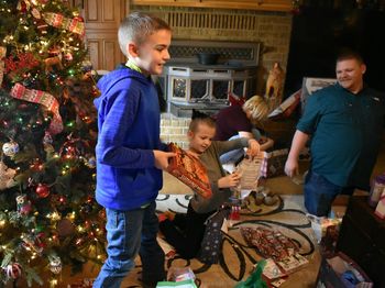 Full length of father and daughter on christmas tree