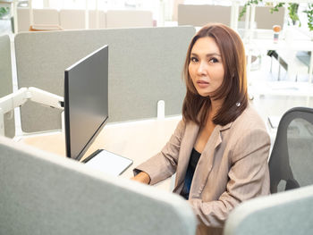 Portrait of businesswoman siting at office