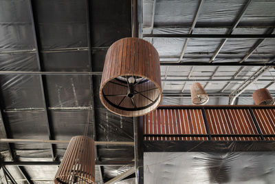 Low angle view of lighting equipment hanging on ceiling