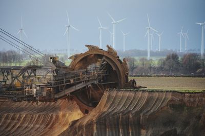 Traditional windmill on field against sky