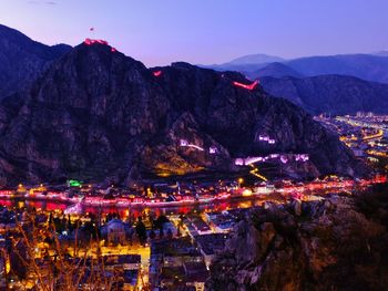 Crowd on illuminated mountain against sky at night