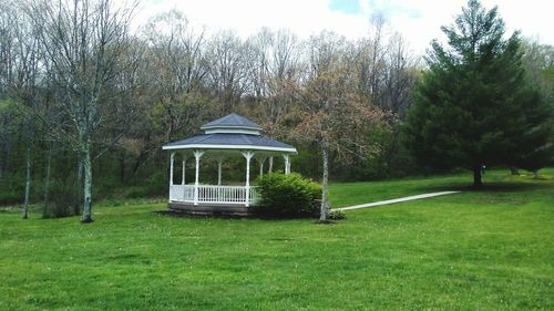 Built structure on field against trees