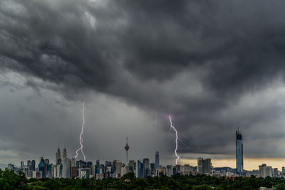 Panoramic view of city against dramatic sky