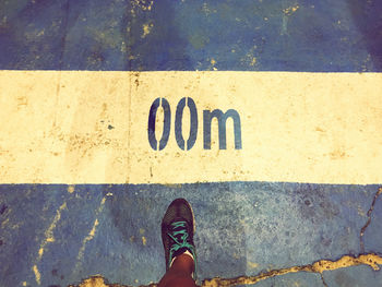 Low section of man standing on street