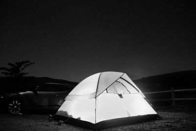 Tent against clear sky at night