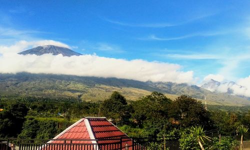 Scenic view of mountains and trees against sky