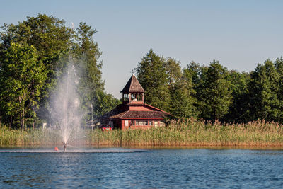 Fountain in lake aluksne near pilssala on a sunny summer afternoon, aluksne, vidzeme, latvia