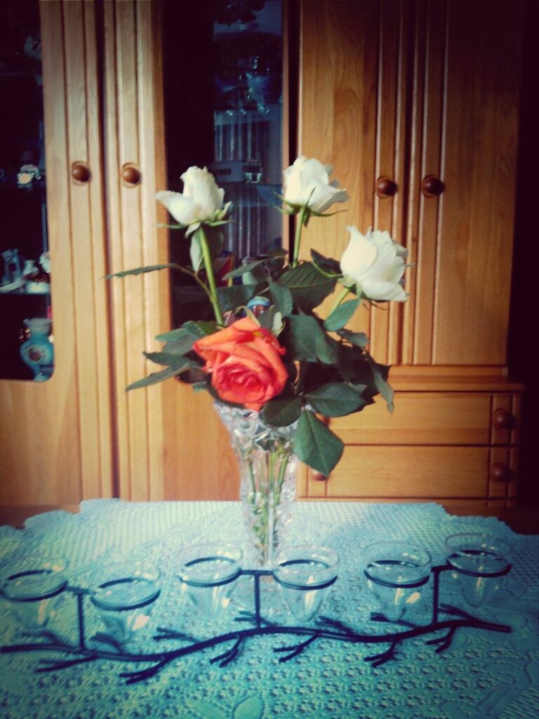 flower, indoors, vase, decoration, table, petal, fragility, home interior, freshness, flower arrangement, wood - material, flower head, window, glass - material, rose - flower, still life, white color, wall - building feature, no people, bouquet