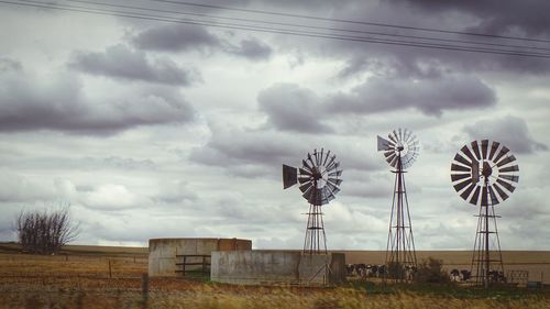 Scenic view of field against cloudy sky