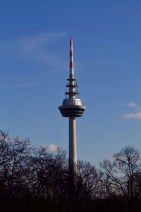 Low angle view of communications tower against sky
