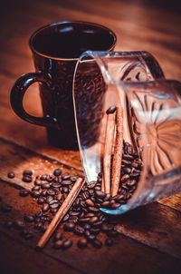 High angle view of coffee beans and cinnamon on table