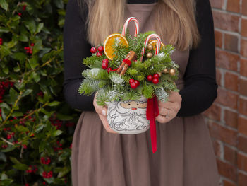 Midsection of woman holding christmas decoration