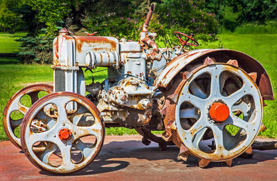 Close-up of old machinery on field