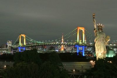Statue of illuminated city at night