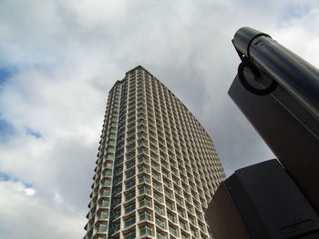 Low angle view of modern building against cloudy sky