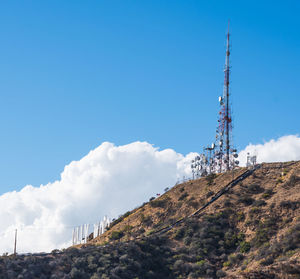 Low angle view of communications tower against blue sky