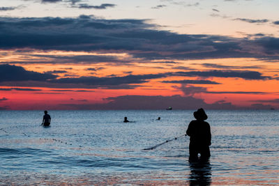 A fisherman is fishing at sunset on koh rong, cambodia