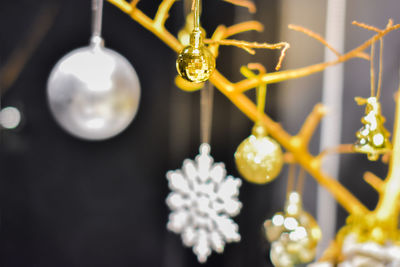 Close-up of illuminated lighting equipment hanging from ceiling