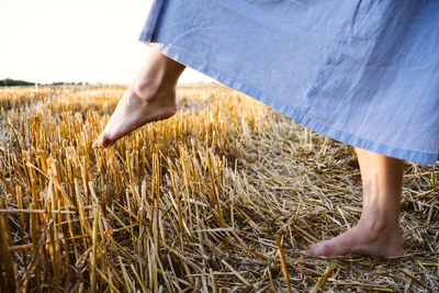 Low section of man standing on field