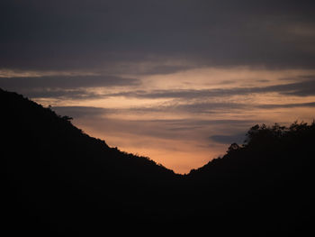 Scenic view of silhouette mountains against sky at sunset