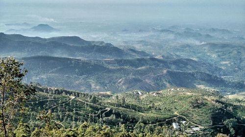 High angle view of small villages in valley during sunny day 