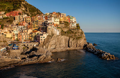 Scenic view of sea by cliff against clear sky