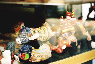 Chinese dragon toys seen through glass at store for sale