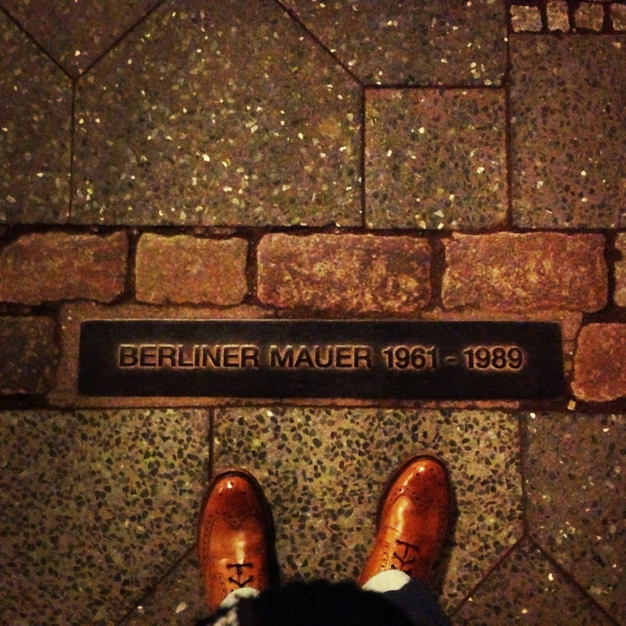 low section, person, shoe, personal perspective, standing, human foot, high angle view, footwear, directly above, text, lifestyles, men, communication, unrecognizable person, street, paving stone, western script
