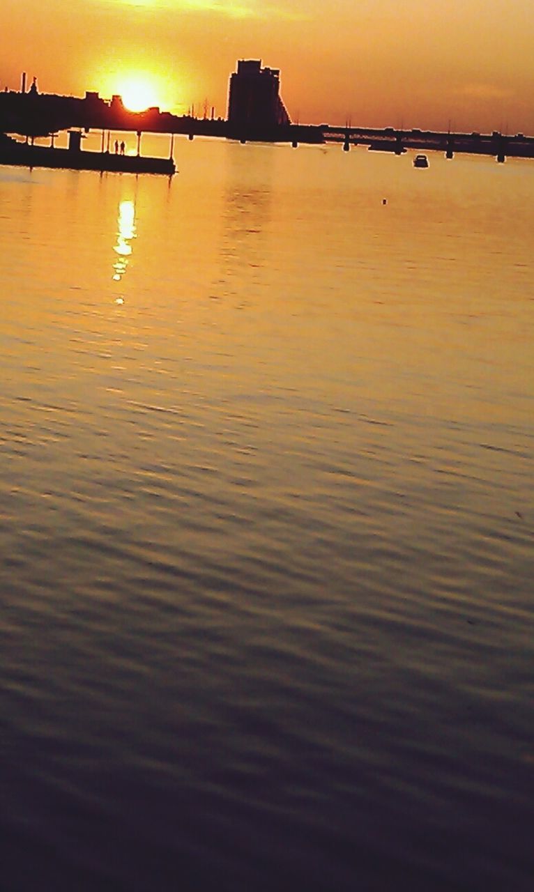 sunset, water, orange color, built structure, architecture, sea, silhouette, reflection, waterfront, sun, river, sky, scenics, bridge - man made structure, tranquility, rippled, connection, tranquil scene, pier, beauty in nature