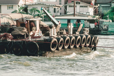 View of boats in sea against built structures