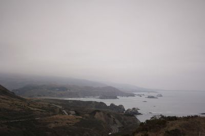 Scenic view of mountains and sea against sky