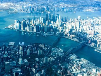 High angle view of cityscape by sea against sky