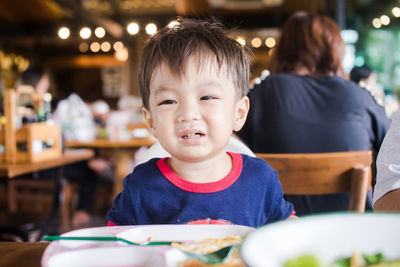 Cute sad baby boy at restaurant