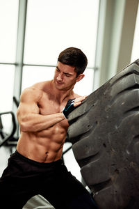 Side view of man exercising in gym