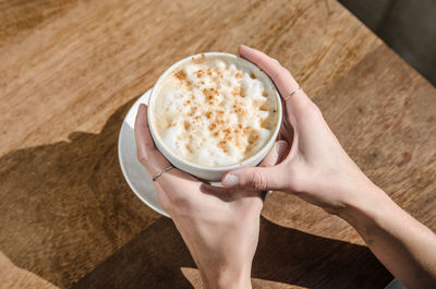 Woman holding coffee cup