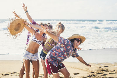 Cheerful friends enjoying on beach