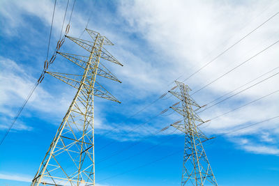 Low angle view of electricity pylon against sky