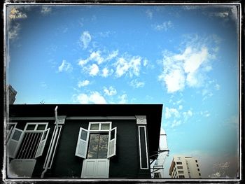 Low angle view of building against blue sky