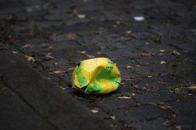 Deflated soccer ball on sidewalk