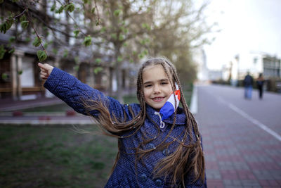 Portrait of girl standing on street