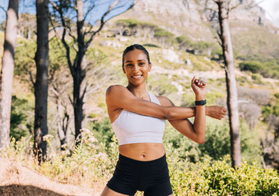 Portrait of young woman exercising in park
