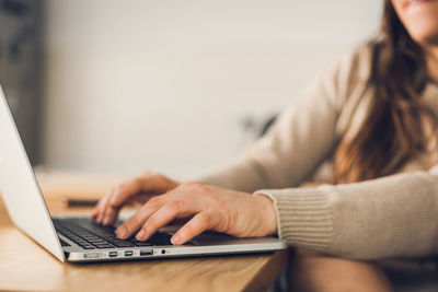 Midsection of woman using mobile phone