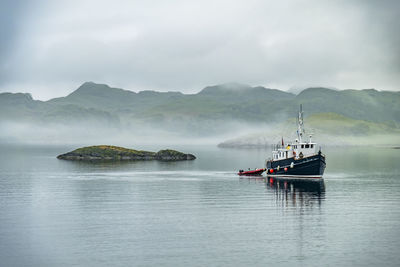 Ship sailing on sea against sky