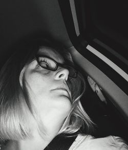 Close-up of young woman in car