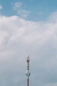 Low angle view of communications tower against sky