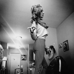 Woman standing on ceiling at home