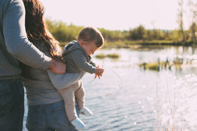 Parents with baby boy at lakeshore